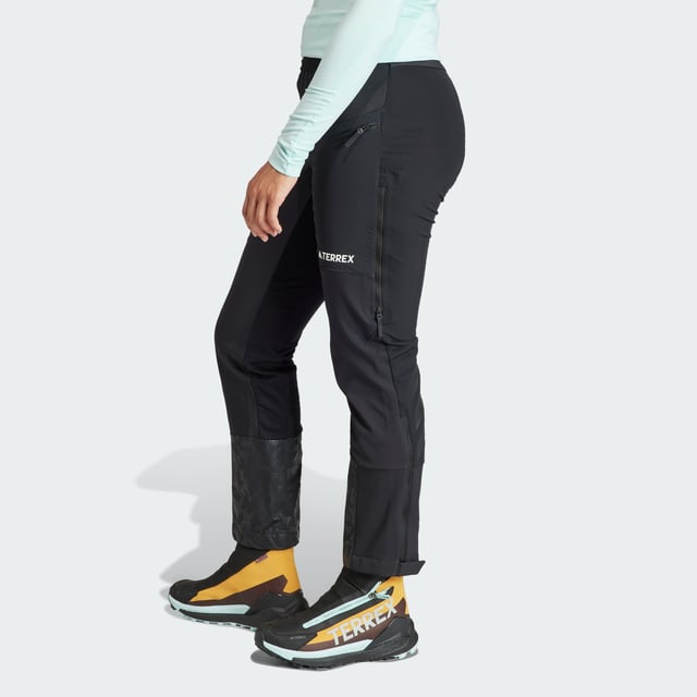 Snowshoeing, ski touring or hiking, these adidas mountain pants keep you warm without adding bulk. Cut for a slim fit and made from a combination of soft shell and stretch fabrics, they offer unrestricted range of motion. Secure the fit around your boots with the zip-adjustable cuffs to seal out dirt or snow. Side vents keep the air flowing to help regulate your temperature when you're out exploring in the elements.  - Slim fit - Drawcord on elastic waist - 100% polyester (recycled) - Thigh pockets with zip - Side vents with zip - Zip-adjustable cuffs with gusset and snap-button closure  Shipped by adidas