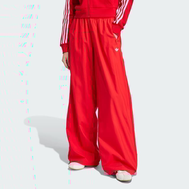 The 3-Stripes on these adidas pants have two purposes — celebrate their adidas DNA boldly, and to emphasise the wide leg silhouette. The flowing look can be adjusted at the cuffs, with a pearl at the stopper of the bungees for added decadence. A two-way zip on the side allows you to play with the aesthetic even further, by creating more of a balloon shape with the volume.This product is made with 100% recycled materials. By reusing materials that have already been created, adidas help to reduce waste and our reliance on finite resources and reduce the footprint of the products adidas make.  - Loose fit - Drawcord on elastic waist - 100% polyester (recycled) - Side pockets - Bungee-adjustable hems  Shipped by adidas