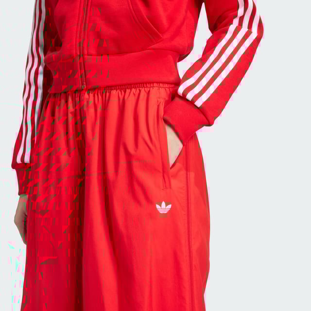 The 3-Stripes on these adidas pants have two purposes — celebrate their adidas DNA boldly, and to emphasise the wide leg silhouette. The flowing look can be adjusted at the cuffs, with a pearl at the stopper of the bungees for added decadence. A two-way zip on the side allows you to play with the aesthetic even further, by creating more of a balloon shape with the volume.This product is made with 100% recycled materials. By reusing materials that have already been created, adidas help to reduce waste and our reliance on finite resources and reduce the footprint of the products adidas make.  - Loose fit - Drawcord on elastic waist - 100% polyester (recycled) - Side pockets - Bungee-adjustable hems  Shipped by adidas