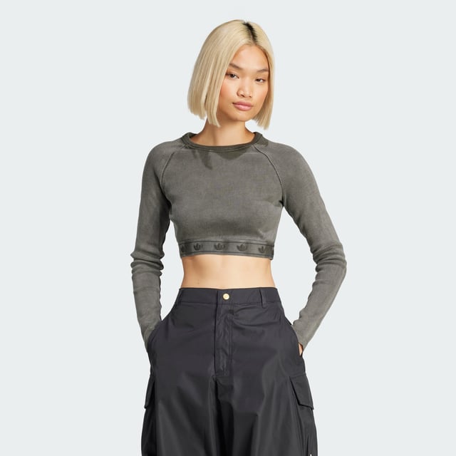 This adidas crop top is inspired by the bold attitudes and style of '90s hip hop. Soft ribbed fabric in a slim silhouette hugs the body while the long sleeves and crewneck give it a casual vibe. It's finished with a repeating Trefoil graphic along the hem.  - Slim fit with crop length - Crewneck - 95% cotton, 5% elastane  Shipped by adidas