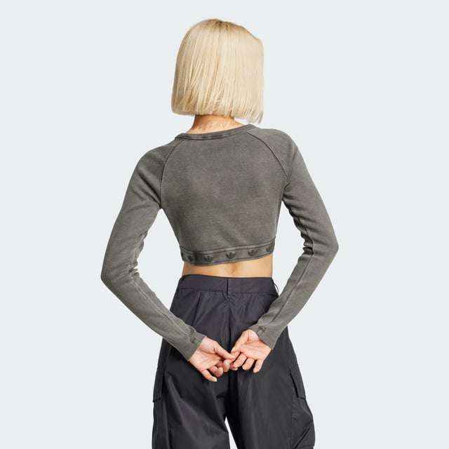 This adidas crop top is inspired by the bold attitudes and style of '90s hip hop. Soft ribbed fabric in a slim silhouette hugs the body while the long sleeves and crewneck give it a casual vibe. It's finished with a repeating Trefoil graphic along the hem.  - Slim fit with crop length - Crewneck - 95% cotton, 5% elastane  Shipped by adidas