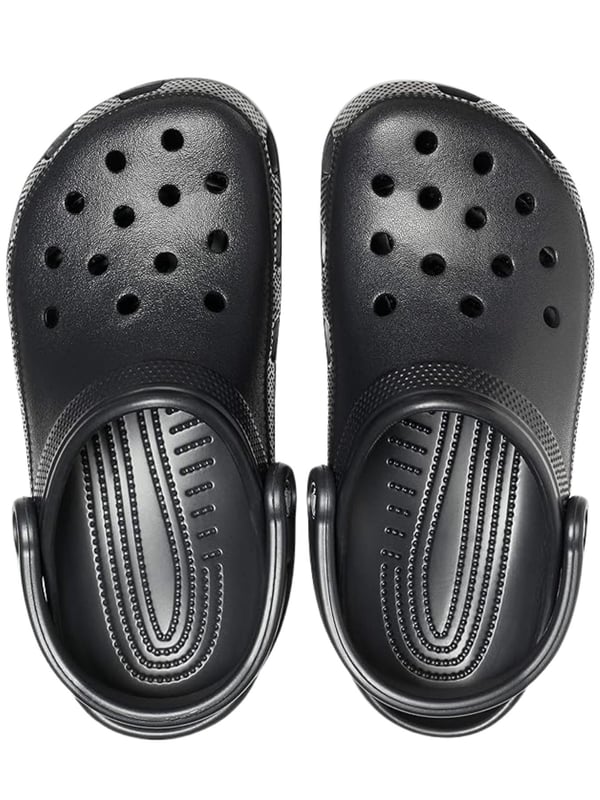 Step into comfort with the Croc Classic Clog, designed for everyday wear and outdoor adventures. Made from fully molded Croslite  material, these clogs offer lightweight cushioning and a custom fit that molds to your foot with excellent arch support. Ventilation ports provide breathability and help water and debris drain away, making them perfect for the beach or boat. With a secure heel strap, quick-drying design, and non-marking soles, these clogs are as practical as they are comfortable.