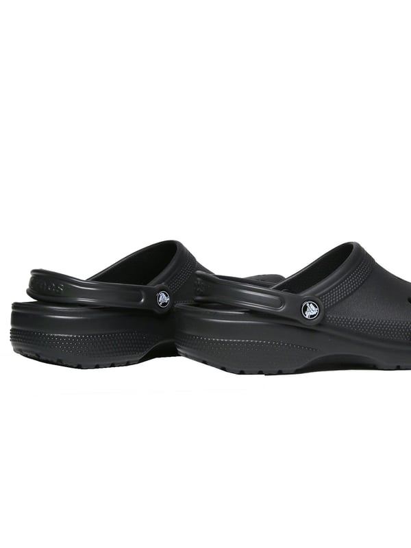 Step into comfort with the Croc Classic Clog, designed for everyday wear and outdoor adventures. Made from fully molded Croslite  material, these clogs offer lightweight cushioning and a custom fit that molds to your foot with excellent arch support. Ventilation ports provide breathability and help water and debris drain away, making them perfect for the beach or boat. With a secure heel strap, quick-drying design, and non-marking soles, these clogs are as practical as they are comfortable.