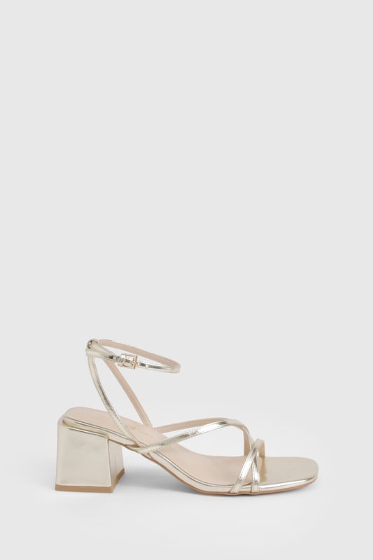 Metallic Crossover Strap Detail Low Block Heels Elegant crossover strap design for a contemporary twist on classic sandals
Comfortable low block heel measuring between 2.5-4.5cm for all-night wearability
Metallic finish that catches the light beautifully as you move
Adjustable ankle strap with secure buckle fastening
Versatile square toe silhouette that complements various outfits
These striking metallic heels strike the perfect balance between style and comfort, featuring delicate crossover straps that create a flattering effect on the foot. The low block heel provides stability whilst adding just enough height to enhance your silhouette without compromising on comfort during those long nights out. Pair with a sleek mini dress and statement earrings for an evening at the club, or style with tailored trousers and a silky camisole when meeting friends for cocktails. The ankle strap ensures a secure fit as you dance the night away, whilst the metallic finish adds a touch of glamour to any ensemble. These versatile heels transition effortlessly from day to night, making them an essential addition to your footwear collection for any social occasion where you want to make an impression without sacrificing comfort.
