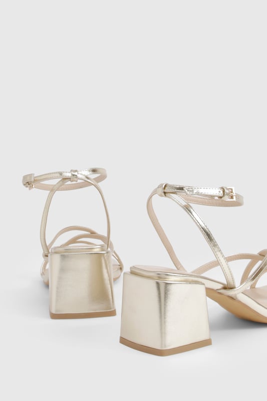 Metallic Crossover Strap Detail Low Block Heels Elegant crossover strap design for a contemporary twist on classic sandals
Comfortable low block heel measuring between 2.5-4.5cm for all-night wearability
Metallic finish that catches the light beautifully as you move
Adjustable ankle strap with secure buckle fastening
Versatile square toe silhouette that complements various outfits
These striking metallic heels strike the perfect balance between style and comfort, featuring delicate crossover straps that create a flattering effect on the foot. The low block heel provides stability whilst adding just enough height to enhance your silhouette without compromising on comfort during those long nights out. Pair with a sleek mini dress and statement earrings for an evening at the club, or style with tailored trousers and a silky camisole when meeting friends for cocktails. The ankle strap ensures a secure fit as you dance the night away, whilst the metallic finish adds a touch of glamour to any ensemble. These versatile heels transition effortlessly from day to night, making them an essential addition to your footwear collection for any social occasion where you want to make an impression without sacrificing comfort.