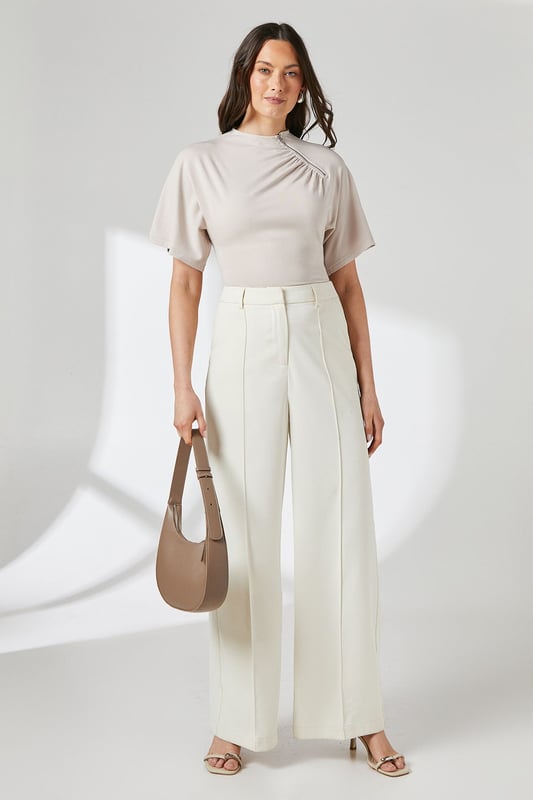 Elegant flutter sleeves for a soft, feminine silhouette
        Distinctive asymmetric zip detail adding contemporary flair
        Flattering crew neckline with subtle gathering detail
        Smooth jersey fabric offering comfortable stretch and movement
        Regular fit design perfect for versatile styling options
    
    This Principles top combines effortless style with practical comfort for your everyday wardrobe. The delicate flutter sleeves create a graceful drape while the unique asymmetric zip detail adds a modern twist to this otherwise classic piece. The gentle gathering at the neckline creates subtle texture and dimension that flatters your dcolletage. Style with wide-leg trousers as shown for a polished daytime look, perfect for family gatherings or weekend brunches. For casual outings, pair with your favourite denim and trainers, or dress up with tailored trousers and ballet flats for office wear. The stretchy jersey composition ensures all-day comfort without compromising on style, making this a versatile piece that transitions seamlessly from morning coffee runs to afternoon shopping trips.