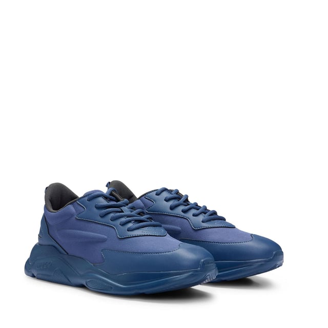 Mens HUGO Leon Running-Inspired Trainers with contrast details in navySignature trainers by HUGO  set on an EVA outsole and crafted in a mix of materials with contrast detailing and branding throughout.- Laces- Partially lined- Packaging: Box- Upper material: 100% Polyester.  Lining: 100% Polyester.  Sole: 100% Ethylene vinyl acetate.  Facing: 60% Polyester  40% Polyurethane.  Innersole: 100% Polyester.- Ref: 50517096-413