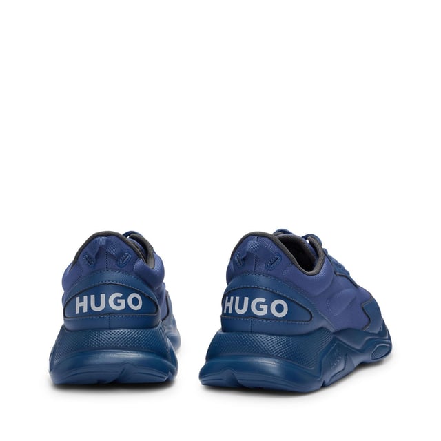 Mens HUGO Leon Running-Inspired Trainers with contrast details in navySignature trainers by HUGO  set on an EVA outsole and crafted in a mix of materials with contrast detailing and branding throughout.- Laces- Partially lined- Packaging: Box- Upper material: 100% Polyester.  Lining: 100% Polyester.  Sole: 100% Ethylene vinyl acetate.  Facing: 60% Polyester  40% Polyurethane.  Innersole: 100% Polyester.- Ref: 50517096-413
