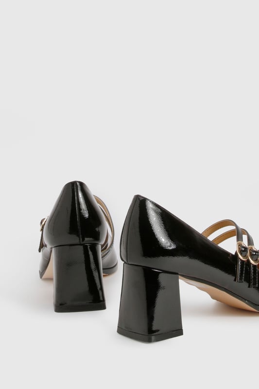 Glossy patent finish for a striking, eye-catching look
        Double strap design with elegant gold-tone buckle detailing
        Classic square toe silhouette for a modern twist on the Mary Jane style
        Comfortable mid block heel measuring between 5-6.5cm in height
        Cushioned insole for all-day wearability and comfort
    
    These Block Heel Double Strap Mary Janes from Boohoo offer a contemporary take on a timeless classic. The distinctive double strap design with polished buckle detailing creates a playful yet sophisticated silhouette that works beautifully for various occasions. Style them with cropped trousers and a crisp blouse for office attire, or pair with a floaty midi dress for family gatherings. The square toe and block heel combination delivers both stability and style, making these shoes perfect for occasions where you'll be on your feet. The patent finish adds a touch of glamour to even the simplest outfit, whilst the mid-height heel strikes the ideal balance between elegance and practicality. These versatile Mary Janes will quickly become a go-to in your footwear collection, offering endless styling possibilities throughout the seasons.