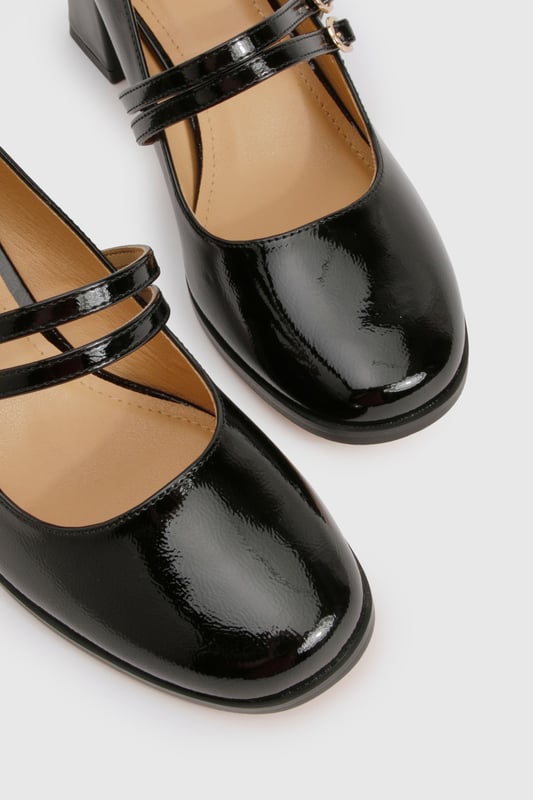 Glossy patent finish for a striking, eye-catching look
        Double strap design with elegant gold-tone buckle detailing
        Classic square toe silhouette for a modern twist on the Mary Jane style
        Comfortable mid block heel measuring between 5-6.5cm in height
        Cushioned insole for all-day wearability and comfort
    
    These Block Heel Double Strap Mary Janes from Boohoo offer a contemporary take on a timeless classic. The distinctive double strap design with polished buckle detailing creates a playful yet sophisticated silhouette that works beautifully for various occasions. Style them with cropped trousers and a crisp blouse for office attire, or pair with a floaty midi dress for family gatherings. The square toe and block heel combination delivers both stability and style, making these shoes perfect for occasions where you'll be on your feet. The patent finish adds a touch of glamour to even the simplest outfit, whilst the mid-height heel strikes the ideal balance between elegance and practicality. These versatile Mary Janes will quickly become a go-to in your footwear collection, offering endless styling possibilities throughout the seasons.