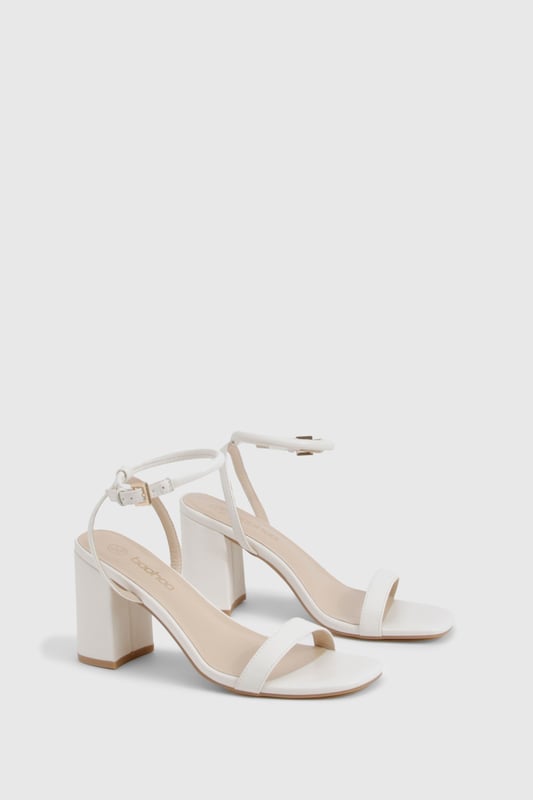 Sleek two-part design with minimalist straps for contemporary appeal
        Comfortable mid block heel measuring between 5-6.5cm for all-night wearability
        Secure ankle strap with adjustable buckle fastening
        Versatile square toe silhouette that complements any outfit
        Smooth PU finish that's easy to style for various occasions
    
    These chic 2 Part Mid Block Heels from Boohoo strike the perfect balance between style and comfort. The minimalist design features clean lines and a contemporary square toe, making them an essential addition to your going-out wardrobe. The practical mid block heel offers stability without sacrificing sophistication, whilst the ankle strap ensures a secure fit as you dance the night away. Style these versatile heels with a slinky midi dress and chain strap bag for drinks with the girls, or pair with tailored trousers and a statement top when heading to the bar. Their understated elegance works brilliantly for both casual meet-ups and more glamorous evening events, offering endless styling possibilities. The modest height makes them comfortable enough to wear from dusk till dawn, proving that you don't need to sacrifice comfort for style.