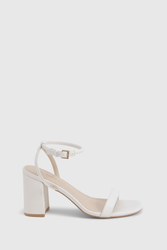 Sleek two-part design with minimalist straps for contemporary appeal
        Comfortable mid block heel measuring between 5-6.5cm for all-night wearability
        Secure ankle strap with adjustable buckle fastening
        Versatile square toe silhouette that complements any outfit
        Smooth PU finish that's easy to style for various occasions
    
    These chic 2 Part Mid Block Heels from Boohoo strike the perfect balance between style and comfort. The minimalist design features clean lines and a contemporary square toe, making them an essential addition to your going-out wardrobe. The practical mid block heel offers stability without sacrificing sophistication, whilst the ankle strap ensures a secure fit as you dance the night away. Style these versatile heels with a slinky midi dress and chain strap bag for drinks with the girls, or pair with tailored trousers and a statement top when heading to the bar. Their understated elegance works brilliantly for both casual meet-ups and more glamorous evening events, offering endless styling possibilities. The modest height makes them comfortable enough to wear from dusk till dawn, proving that you don't need to sacrifice comfort for style.