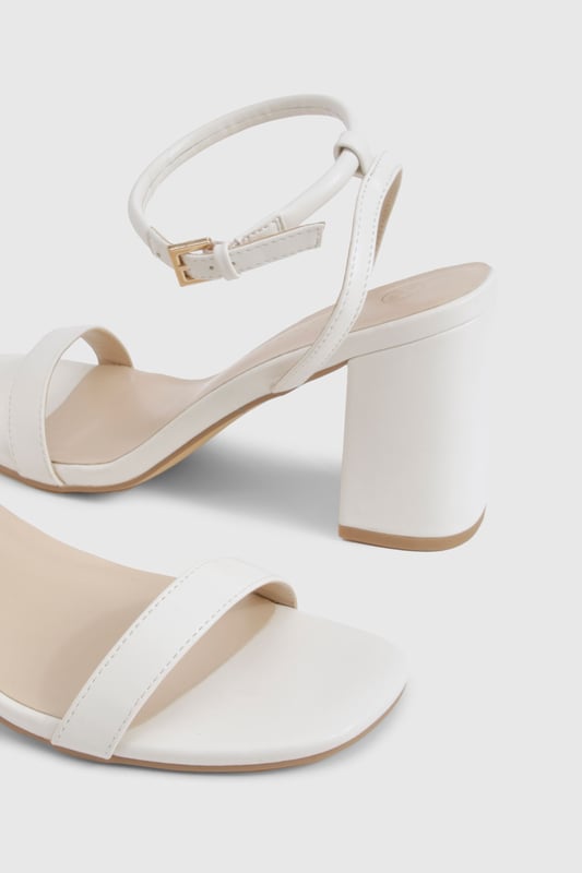 Sleek two-part design with minimalist straps for contemporary appeal
        Comfortable mid block heel measuring between 5-6.5cm for all-night wearability
        Secure ankle strap with adjustable buckle fastening
        Versatile square toe silhouette that complements any outfit
        Smooth PU finish that's easy to style for various occasions
    
    These chic 2 Part Mid Block Heels from Boohoo strike the perfect balance between style and comfort. The minimalist design features clean lines and a contemporary square toe, making them an essential addition to your going-out wardrobe. The practical mid block heel offers stability without sacrificing sophistication, whilst the ankle strap ensures a secure fit as you dance the night away. Style these versatile heels with a slinky midi dress and chain strap bag for drinks with the girls, or pair with tailored trousers and a statement top when heading to the bar. Their understated elegance works brilliantly for both casual meet-ups and more glamorous evening events, offering endless styling possibilities. The modest height makes them comfortable enough to wear from dusk till dawn, proving that you don't need to sacrifice comfort for style.