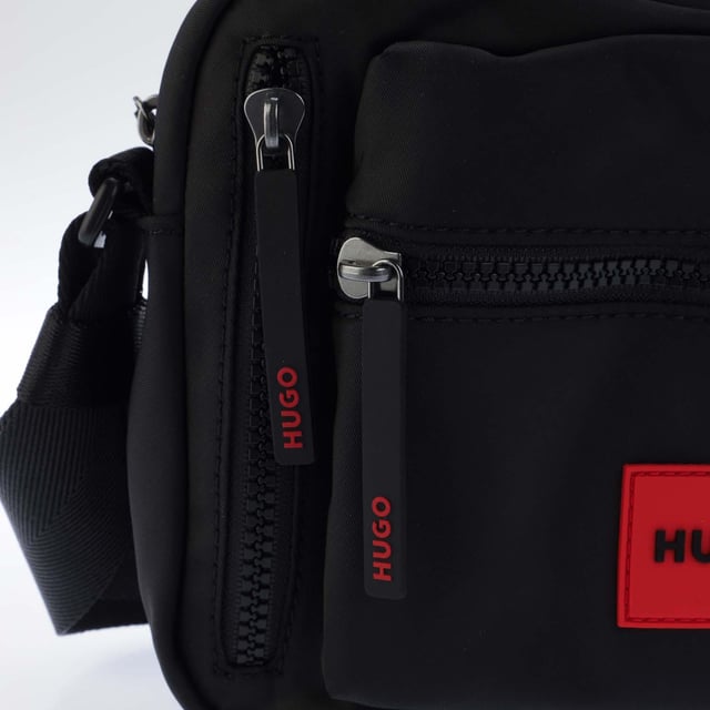 Hugo Boss Ethon 2.0 Crossbody Bag in black.- One main compartment.- Adjustable shoulder strap.- Two zip pockets on the front.- One slip pocket.- 100% Polyester.- Ref: 50535643002