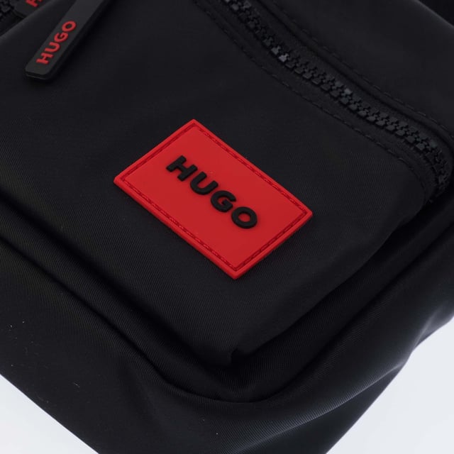 Hugo Boss Ethon 2.0 Crossbody Bag in black.- One main compartment.- Adjustable shoulder strap.- Two zip pockets on the front.- One slip pocket.- 100% Polyester.- Ref: 50535643002