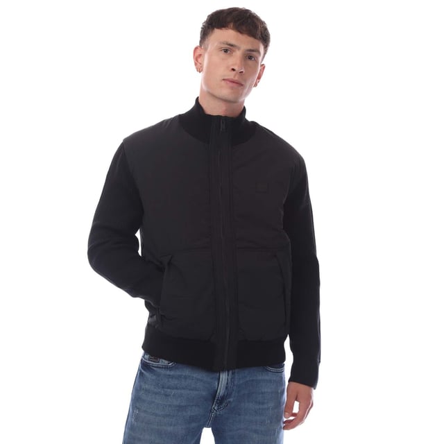 Mens Hugo Boss Kydalnrio Hybrid Jacket in black.- Funnel neck.- Full zip fastening.- Two front pockets.- Ribbed cuffs and hem.- Nylon front.- Square Boss badge on the chest.- Knitted.- 40% Acrylic  39% Virgin Wool  18% Polyamide  3% Elastane.- Ref: 50531494001