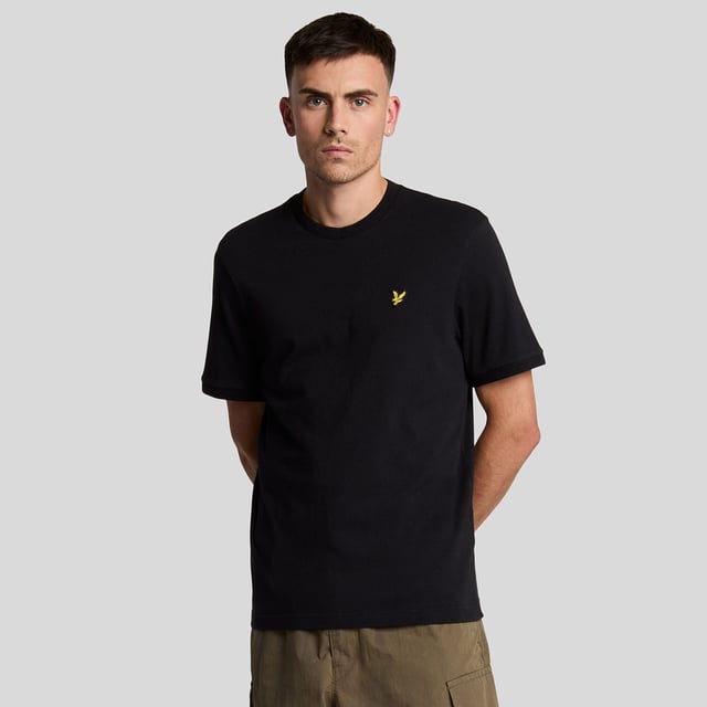 Crew neck design with fine ribbed collar.Short sleeves.Finished with tonal tipped stitching at the cuffs and neckline.Rib knit cuffs.Embroidered Golden Eagle Logo to chest.