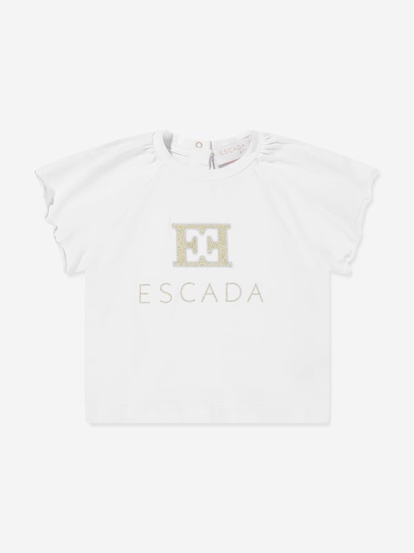 Introducing Escada's Baby Girls Embroidered Logo T-Shirt in pristine white for SS2025. A luxurious staple for the tiny trendsetters wardrobe, splendidly capturing the essence of high-end simplicity. Key features include Exquisite Embroidery Features the iconic Escada logo delicately embroidered, adding a touch of elegance. Luxurious Comfort Crafted from superior soft cotton, ensuring comfort for all-day wear. Versatile Style Perfect for any occasion, from playdates to parties.Elevate your little girl's ensemble with this timeless piece from Escada.