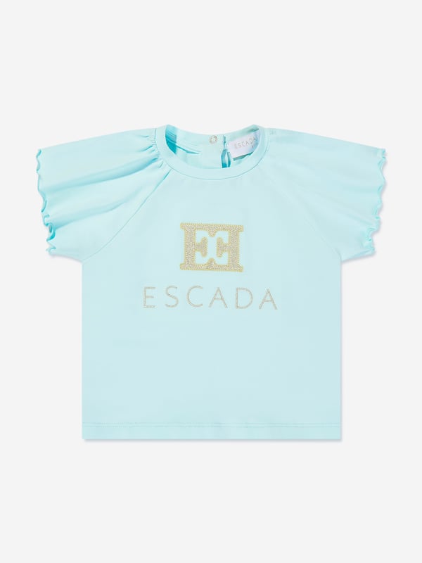 Introducing the Escada Baby Girls Embroidered Logo T-Shirt in Blue, an exquisite addition to your little princess's wardrobe for SS2025. Revel in the charm and class of this essential piece Exquisite Embroidery Features the iconic Escada logo delicately embroidered, adding a touch of luxury. Premium Fabric Crafted from the finest materials, ensuring comfort durability for all-day wear. Versatile Shade A beautiful blue hue that complements any outfit, making it a versatile staple. Perfect for Special Occasions Ideal for garden parties or family gatherings.Elevate her style with Escada's sophistication.