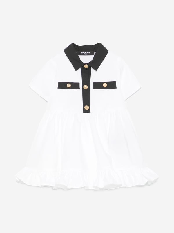Introducing the exquisitely designed Baby Girls Polo Dress with Knickers in White by Balmain. Crafted in Italy, this essential piece epitomizes luxury and sophistication for SS2025. Features include Impeccable Italian Craftsmanship Precision-made for durability and timeless style. Pristine White Hue A classic, crisp white that complements any occasion. Luxurious Comfort Constructed from premium fabrics to ensure your little one enjoys supreme comfort. Coordinated Ensemble Comes with matching knickers for a complete, stylish look.Elevate her wardrobe with this quintessential Balmain set!