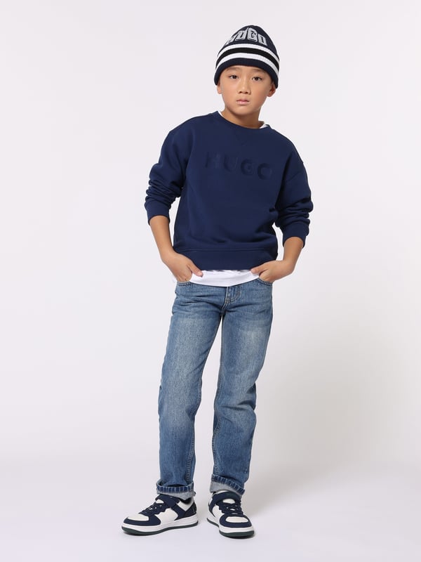 Introducing the Hugo Hoodie in majestic blue tailored for boys for AW2024. Exquisitely crafted, this piece melds luxury with practicality to elevate any young wardrobe. Heres why it's indispensable Vibrant Azure Hue Captures the richness of the season in a compelling, stylish shade of blue. Premium Fabric Blend Ensures durability and all-day comfort, ideal for energetic boys. Contemporary Cut A modern, clean design that seamlessly fits with other wardrobe pieces.revitalise your boy's collection with the Hugo Hoodie in blue. Order nowlet him shine in sophistication this AW2024!