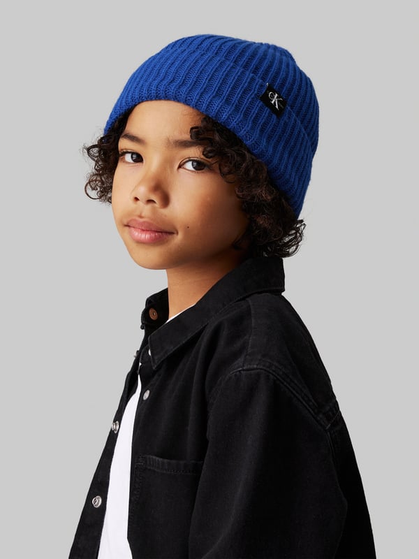 Introducing the Boys Monogram Rib Beanie Hat in Blue, crafted by Calvin Klein Jeans a premier accessory for the discerning young wardrobe for AW2024. Experience sophistication and cosy warmth with every wear Signature Monogram Design Features Calvin Klein's iconic logo in a subtle, stylish monogram pattern. Luxe Fabric Blend Constructed with premium materials, ensuring a soft touch and durable wear. Vibrant Blue Hue A striking blue colour that complements any outfit, making it both versatile and fashionable. Perfect Fit Ribbed knit offers a snug, comfortable fit that stays in place during all activities.Revamp your boy's style statement with this sophisticated and chic beanie. Ideal for chilly days and cool evenings, let him showcase his flair in Calvin Klein comfort and style!