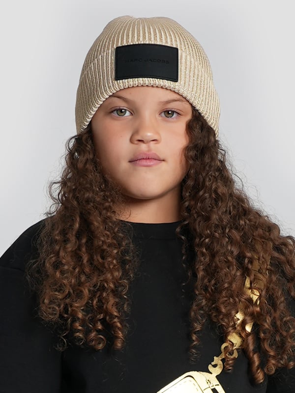 Introducing the Girls Knitted Logo Beanie Hat in Gold from marc_jacobs, the pinnacle of AW2024 chic for your girl. Embrace the elegance and warmth of this must-have accessory. Luxurious Material Crafted with premium yarns for a soft, Cosy feel. Striking Gold Tone A rich, eye-catching gold hue that radiates style and sophistication. Signature Logo Design Adorned with the iconic marc_jacobs logo for an unmistakable touch of luxury.Transform her look this season with the marc_jacob's Gold Beanie. A blend of comfort, style, and warmth, perfect for the fashion-forward youngster.