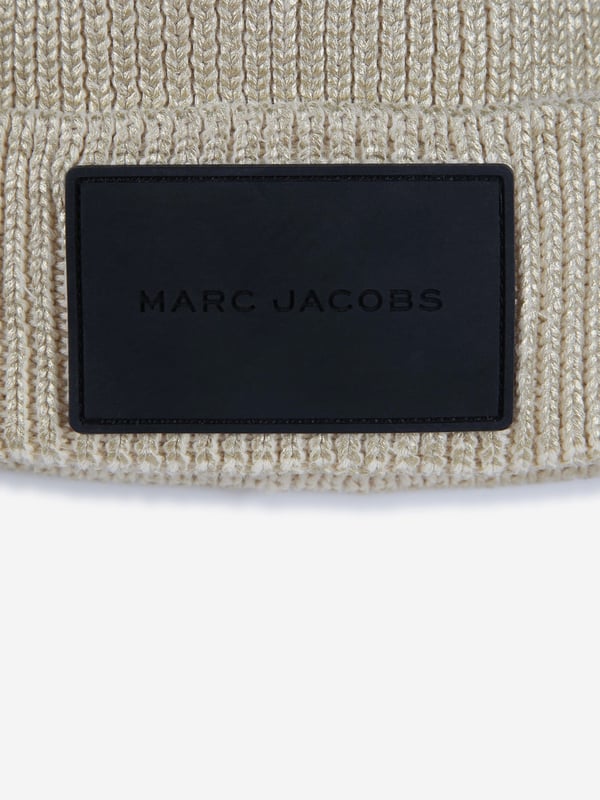 Introducing the Girls Knitted Logo Beanie Hat in Gold from marc_jacobs, the pinnacle of AW2024 chic for your girl. Embrace the elegance and warmth of this must-have accessory. Luxurious Material Crafted with premium yarns for a soft, Cosy feel. Striking Gold Tone A rich, eye-catching gold hue that radiates style and sophistication. Signature Logo Design Adorned with the iconic marc_jacobs logo for an unmistakable touch of luxury.Transform her look this season with the marc_jacob's Gold Beanie. A blend of comfort, style, and warmth, perfect for the fashion-forward youngster.