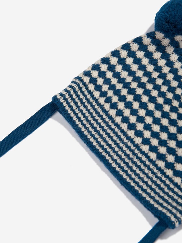 Introducing the Boys Hazel Chunky Checker Hat in Blue by the bonnie mob. Designed to strike a balance between style and warmth for AW2024, this hat is an exquisite addition to any Baby, Baby Boy, or Boy's wardrobe. Discover its standout features Luxe Comfort Crafted with premium, soft materials to ensure warmth and comfort in the cooler months. Eye-Catching Design Features a bold, chunky checker pattern in striking blue shades that enhance any outfit. Versatile Style Suitable for casual outings and special occasions, complementing any ensemble effortlessly. Durable Quality Constructed to endure, maintaining style and comfort through the season.Elevate your child's look with this sophisticated piece from the bonnie mob!