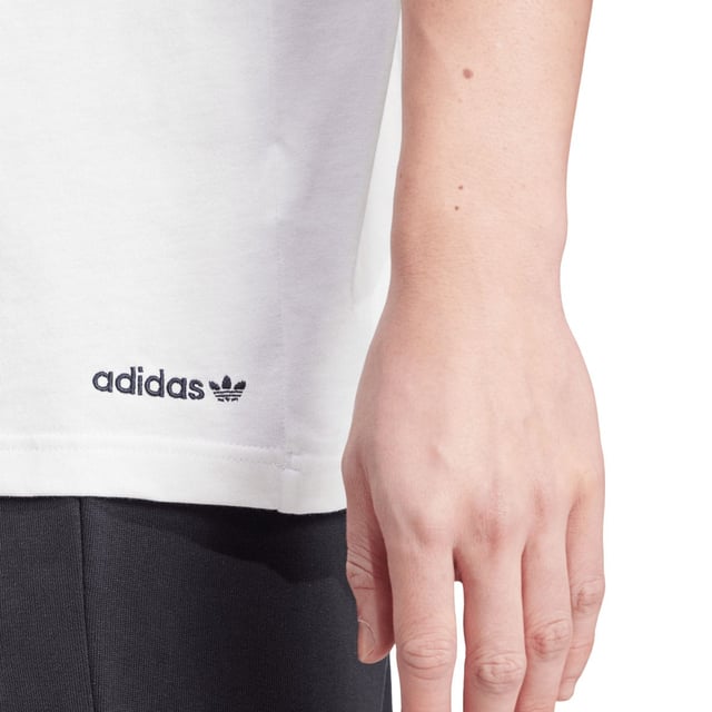 Mens adidas Originals Graphic T-Shirt in cloud whiteSlip into this adidas tee and show off retro-cool style. Inspired by one of the biggest sporting events in the world  a colourful logo graphic anchors your look in legacy. Smooth cotton keeps it casual and comfortable. Pair it with joggers for a laid-back vibe or distressed jeans to remix the retro inspiration.- Celebrate sport in this comfy tee.- Regular fit- Ribbed crewneck- 100% cotton- Machine wash cold delicate cycle- Ref: IW3237
