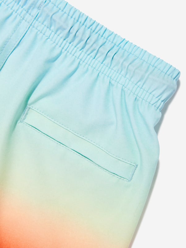 Elevate your young gentleman's summer wardrobe with the Boys Niko Fade Swim Shorts in Blue UPF50 from Molo. Perfect for the stylish SS2025 season, these shorts blend function with fashion flawlessly. Here's why they're essential Striking Ombre Design Seamlessly transitions from light to dark blue, ensuring your boy stays at the forefront of beachside fashion. Enhanced Sun Protection Crafted with UPF50 fabric, these shorts offer superior UV defence, keeping playtime safe and sunburn at bay. Supreme Fabric Quality Breathable, quick-drying material ensures comfort during both aquatic and land activities.Step up his style game with Molo's latest. Shop today!