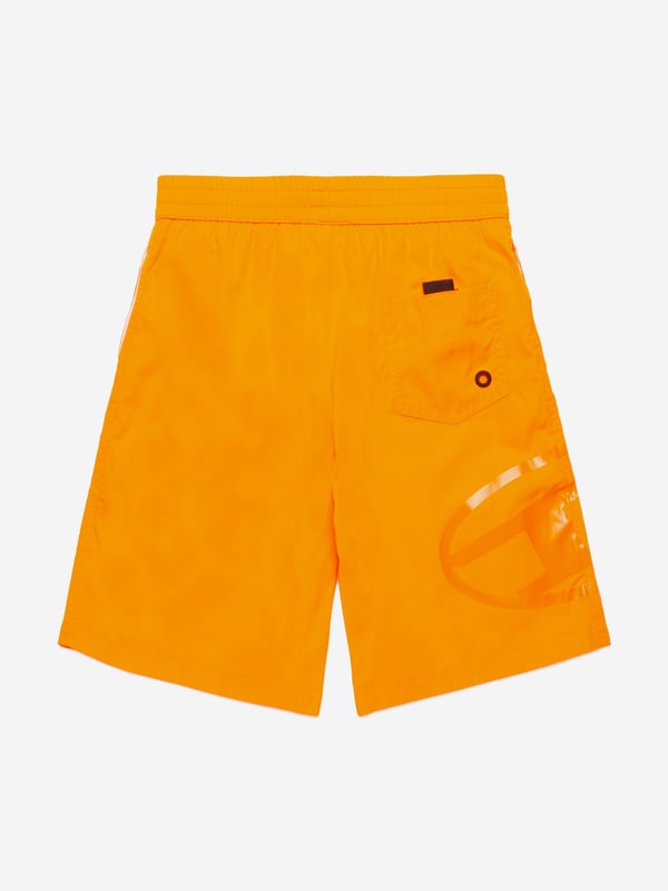 Introducing the Boys Oval D Logo Swim Shorts in Orange by Diesel, an essential addition to your young trendsetter's SS2025 wardrobe. Each detail is meticulously crafted to blend high fashion with functionality Signature Oval D Emblem A mark of high-end style from Diesel, prominently featured. Vibrant Orange Hue Eye-catching and perfect for sunny summer days. Premium Material Guarantees durability and comfort during swim and play.Elevate your boys swimwear collection with these chic and playful shorts. Available now for the fashion-forward youth!