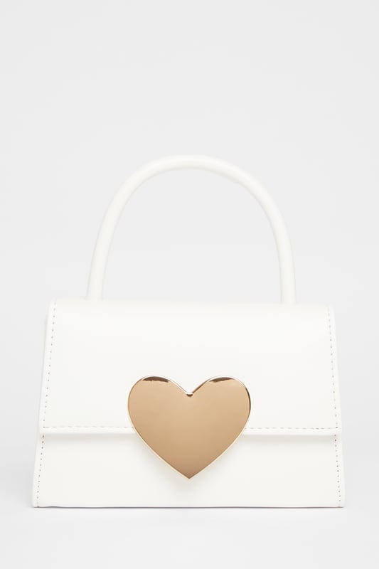 - Faux leather - Patent finish - Metal heart design - Top handle - Flap closure - Length: 5cm - Depth: 6cm - Height: 12.5cm approx - Excluding trims