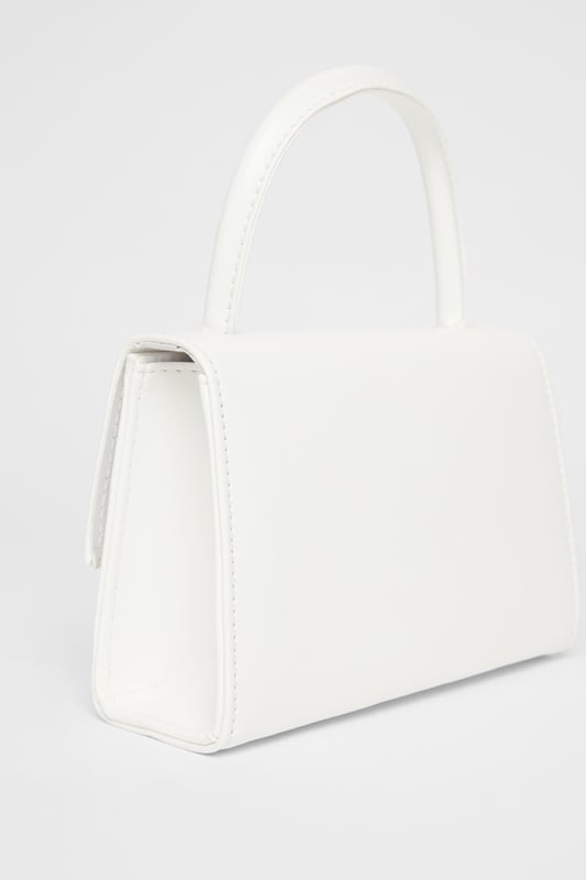 - Faux leather - Patent finish - Metal heart design - Top handle - Flap closure - Length: 5cm - Depth: 6cm - Height: 12.5cm approx - Excluding trims