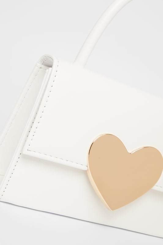 - Faux leather - Patent finish - Metal heart design - Top handle - Flap closure - Length: 5cm - Depth: 6cm - Height: 12.5cm approx - Excluding trims