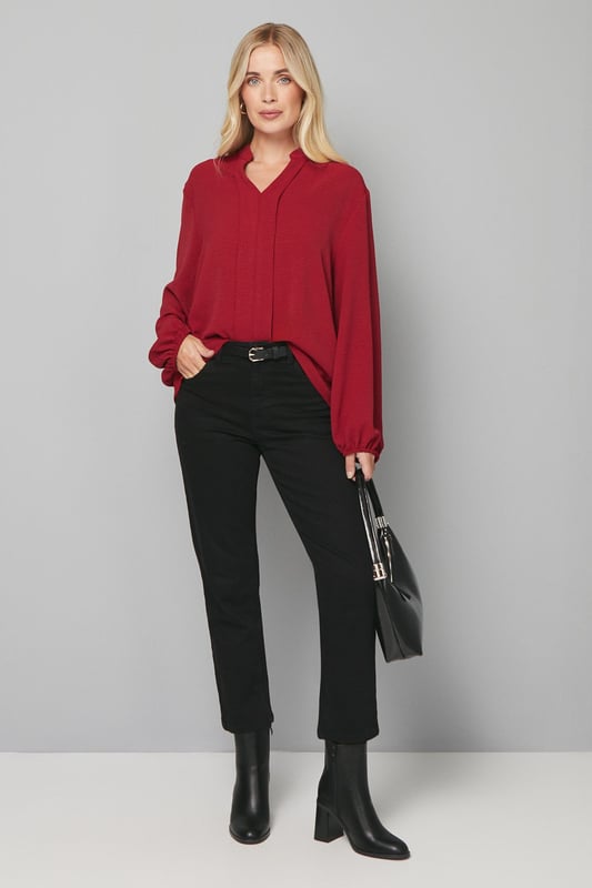 Elegant collarless design with a flattering V-neckline
        Relaxed silhouette with full-length sleeves for sophisticated comfort
        Lightweight woven fabric that drapes beautifully
        Versatile blouse perfect for creating both casual and smart looks
        Petite fit designed specifically for smaller frames
    
    This Wallis collarless blouse combines effortless style with day-to-day versatility. The clean lines and absence of a traditional collar create a modern, streamlined look that's both sophisticated and relaxed. Style with leather-look trousers and ankle boots for a contemporary daytime ensemble, or pair with tailored wide-leg trousers and ballet flats for family gatherings. The flowing fabric and comfortable regular fit make this blouse ideal for long days at the office or weekend brunches with friends. Add a structured tote and simple gold-toned jewellery to complete your look. This wardrobe essential transitions seamlessly from desk to dinner, offering endless styling possibilities whilst maintaining that signature Wallis glamour that doesn't compromise on comfort.