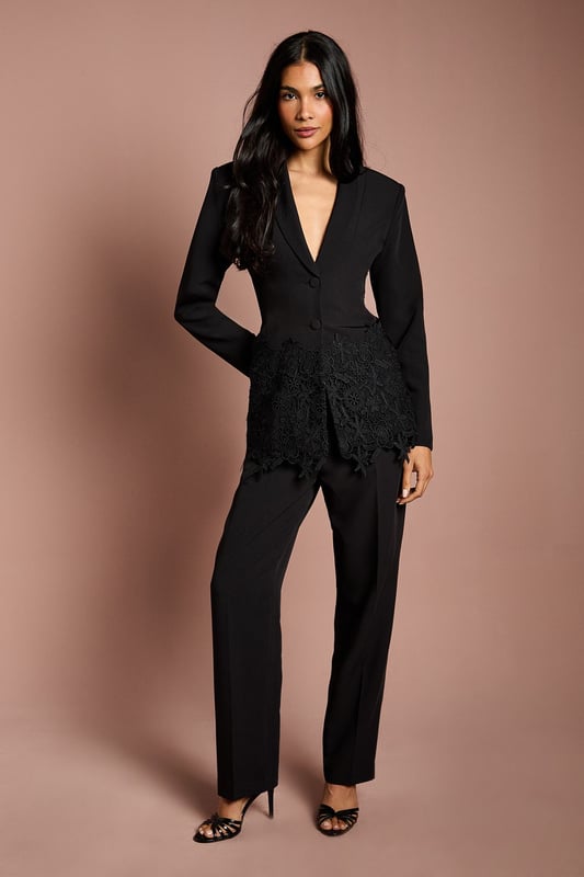 Tailored crepe blazer with elegant lace trim detailing along the hemline
        Sophisticated V-neckline with single-breasted button fastening
        Fitted silhouette that accentuates the waistline for a flattering shape
        Long sleeves with subtle structured shoulders for a refined look
        Versatile design suitable for formal occasions and evening events
    
    This exquisite Coast blazer combines timeless tailoring with delicate lace detailing for a contemporary twist on occasion wear. The fitted silhouette creates a beautifully feminine shape, whilst the crepe fabric offers structure with comfortable movement. Style with the matching trousers as seen for a sophisticated coordinated ensemble, or pair with a sleek midi skirt for an alternative take on formal dressing. Perfect for weddings and race day events, this blazer can be dressed up with statement earrings and a clutch bag. For evening occasions, layer over a silk camisole with tailored trousers and strappy heels. The versatile design ensures this piece will become a cornerstone of your occasion wardrobe, offering endless styling possibilities whilst maintaining an air of understated elegance.