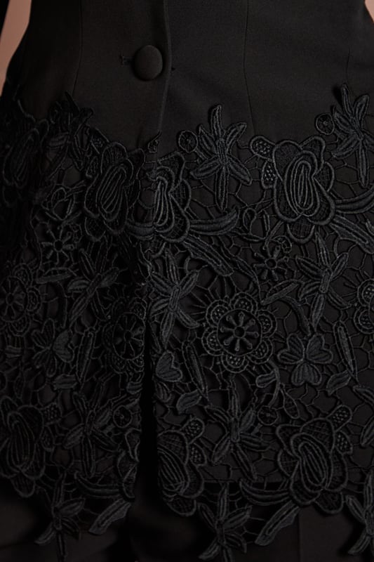 Tailored crepe blazer with elegant lace trim detailing along the hemline
        Sophisticated V-neckline with single-breasted button fastening
        Fitted silhouette that accentuates the waistline for a flattering shape
        Long sleeves with subtle structured shoulders for a refined look
        Versatile design suitable for formal occasions and evening events
    
    This exquisite Coast blazer combines timeless tailoring with delicate lace detailing for a contemporary twist on occasion wear. The fitted silhouette creates a beautifully feminine shape, whilst the crepe fabric offers structure with comfortable movement. Style with the matching trousers as seen for a sophisticated coordinated ensemble, or pair with a sleek midi skirt for an alternative take on formal dressing. Perfect for weddings and race day events, this blazer can be dressed up with statement earrings and a clutch bag. For evening occasions, layer over a silk camisole with tailored trousers and strappy heels. The versatile design ensures this piece will become a cornerstone of your occasion wardrobe, offering endless styling possibilities whilst maintaining an air of understated elegance.