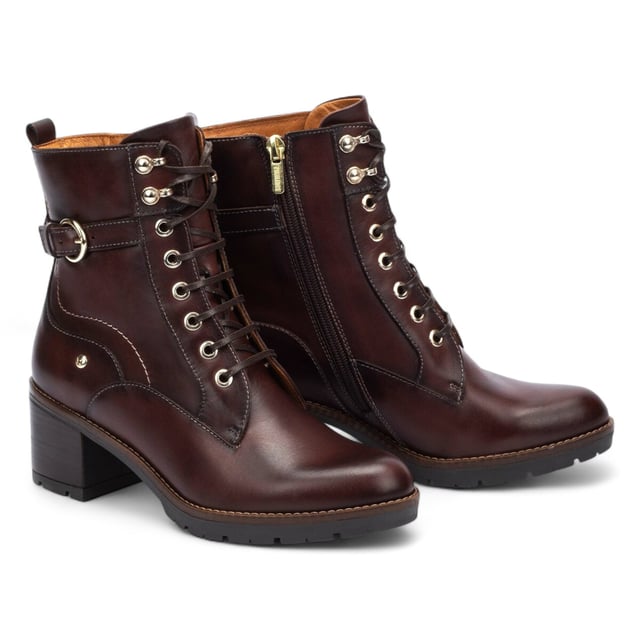 Step into timeless comfort with the Pikolinos Llanes ankle boots – a perfect blend of elegance, functionality, and warmth for colder days. Crafted from premium calfskin leather, these boots feature a flattering 6 cm mid heel and padded insoles for lasting comfort. With a stylish lace-up front and convenient side zip, the Llanes boots are designed to keep your feet supported while elevating your look. Whether you're heading out for errands or styling up for the evening, these boots deliver all-day ease with classic sophistication.

Key Features:
Upper: 100% calfskin leather for a premium, durable finish
Lining: 75% textile and 25% pig skin for a soft, breathable interior
Sole: 100% synthetic for long-lasting grip and flexibility
Closure: Lace-up front with side zip for easy on/off
Heel Height: 6 cm (2.36") flattering mid heel
Shaft Height: 13 cm (5.12"); Shaft Contour: 25 cm (9.84")
Features: Extra comfort insoles for all-day support
Style: Elegant and versatile – ideal for cold weather wear