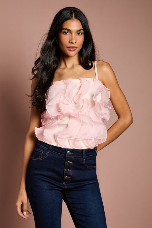 Strapless bandeau design with delicate adjustable straps for versatile styling options
        Luxurious organza fabric with dramatic ruffle detailing across the bodice
        Textured 3D floral effect creates eye-catching dimension and movement
        Elegant regular fit with a fully lined interior for comfort and structure
        Sophisticated cropped length perfect for high-waisted bottoms
    
    This striking Coast cami top presents a masterclass in occasion dressing with its show-stopping ruffle detail. The strapless bandeau design with optional thin straps offers styling flexibility, whilst the textured organza creates a captivating floral effect that catches the light beautifully. Style with tailored high-waisted trousers and pointed court shoes for sophisticated wedding guest attire, or pair with a sleek pencil skirt for summer garden parties and race day events. The regular fit ensures comfort without compromising on elegance, making this piece ideal for dancing the night away at formal celebrations. For cooler evenings, layer with a fitted blazer to maintain the silhouette's refined structure whilst adding a touch of contemporary sophistication to your occasion ensemble.