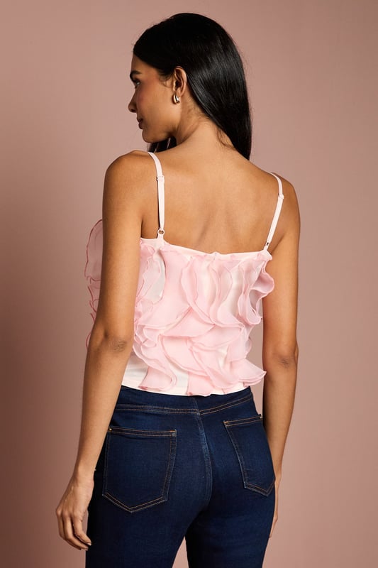 Strapless bandeau design with delicate adjustable straps for versatile styling options
        Luxurious organza fabric with dramatic ruffle detailing across the bodice
        Textured 3D floral effect creates eye-catching dimension and movement
        Elegant regular fit with a fully lined interior for comfort and structure
        Sophisticated cropped length perfect for high-waisted bottoms
    
    This striking Coast cami top presents a masterclass in occasion dressing with its show-stopping ruffle detail. The strapless bandeau design with optional thin straps offers styling flexibility, whilst the textured organza creates a captivating floral effect that catches the light beautifully. Style with tailored high-waisted trousers and pointed court shoes for sophisticated wedding guest attire, or pair with a sleek pencil skirt for summer garden parties and race day events. The regular fit ensures comfort without compromising on elegance, making this piece ideal for dancing the night away at formal celebrations. For cooler evenings, layer with a fitted blazer to maintain the silhouette's refined structure whilst adding a touch of contemporary sophistication to your occasion ensemble.