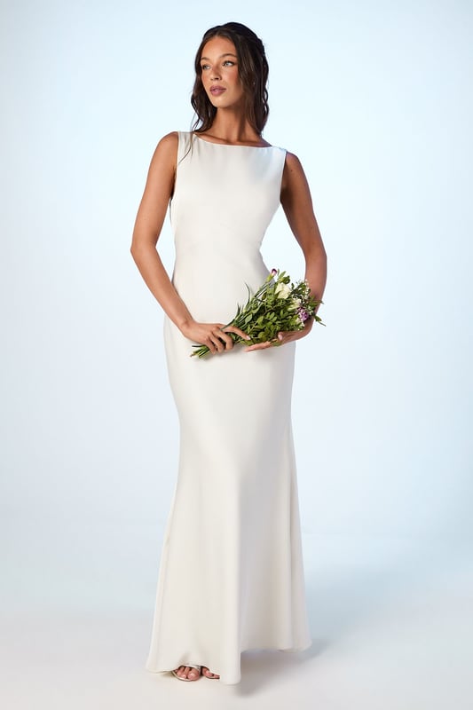 Elegant satin maxi dress with a sophisticated square neckline
        Striking V-back design with a dramatic sash detail that flows beautifully
        Figure-flattering silhouette with a floor-sweeping maxi length
        Sleeveless design perfect for formal wedding celebrations
        Smooth satin fabric creates a luxurious drape and refined finish
    
    This stunning Coast bridesmaid dress combines timeless elegance with contemporary design elements. The clean lines of the square neckline create a graceful frame for the dcolletage, whilst the dramatic V-back with flowing sash detail adds unexpected visual interest when you turn. The sleek silhouette skims the body beautifully before extending to a floor-length finish, creating a sophisticated and elongating effect. Style with delicate strappy heels and refined jewellery for a coordinated bridal party look. The versatile design allows for various styling options within your wedding colour palette, making it ideal for creating a cohesive yet distinctive bridesmaid ensemble. This dress strikes the perfect balance between understated refinement and special occasion glamour, ensuring you feel confident and elegant whilst supporting the bride on her special day.