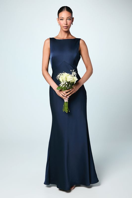 Elegant satin maxi dress with a sophisticated square neckline
        Striking V-back design with a dramatic sash detail that flows beautifully
        Figure-flattering silhouette with a floor-sweeping maxi length
        Sleeveless design perfect for formal wedding celebrations
        Smooth satin fabric creates a luxurious drape and refined finish
    
    This stunning Coast bridesmaid dress combines timeless elegance with contemporary design elements. The clean lines of the square neckline create a graceful frame for the dcolletage, whilst the dramatic V-back with flowing sash detail adds unexpected visual interest when you turn. The sleek silhouette skims the body beautifully before extending to a floor-length finish, creating a sophisticated and elongating effect. Style with delicate strappy heels and refined jewellery for a coordinated bridal party look. The versatile design allows for various styling options within your wedding colour palette, making it ideal for creating a cohesive yet distinctive bridesmaid ensemble. This dress strikes the perfect balance between understated refinement and special occasion glamour, ensuring you feel confident and elegant whilst supporting the bride on her special day.