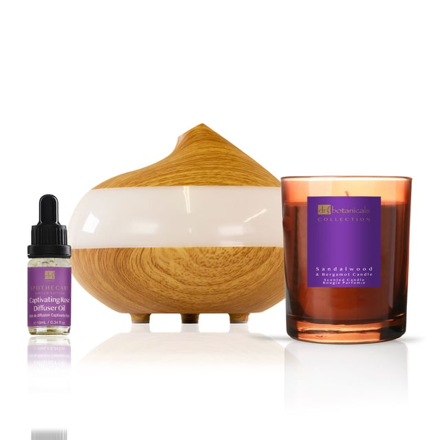 Dr Botanicals Deluxe Relaxation Rose Diffuser Kit with Sandalwood & Bergamot Candle Transform your home into a serene oasis with our Captivating Rose Diffuser Kit, the perfect companion for creating a romantic and relaxing atmosphere. Infuse your space with the delicate fragrance of rose, enhanced by soothing notes of sandalwood and bergamot, to elevate your mood and promote tranquillity. This exquisite kit includes a 10ml Rose Diffuser Oil and a 130ml Natural Wooden Aroma Diffuser, featuring seven changing light colours and two mist modes for a personalised touch. Ideal for conscious consumers, our vegan and cruelty-free product also comes with a Sandalwood & Bergamot candle, adding an extra layer of elegance. Experience the allure and relaxation today—shop now to transform your environment into a love-filled retreat.