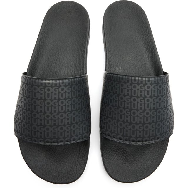 Sleek and sophisticated, the Hugo Timein slides in classic black offer comfort without compromising on style. These rubber sandals boast a contoured footbed that cradles your feet for all-day wearability. The textured outsole provides reliable grip, making them perfect for poolside lounging or casual summer outings. Effortlessly cool with HUGO's signature aesthetic, these slides combine practicality and contemporary design for the modern man.