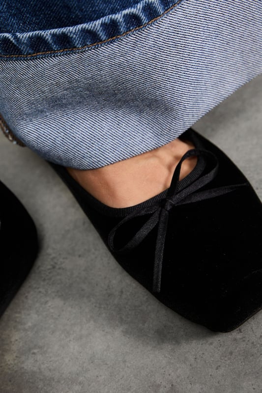 Luxurious velvet ballet pumps with elegant square toe design
        Delicate bow detail on the front for a feminine touch
        Comfortable flat heel measuring between 0-2cm for all-day wear
        Soft cushioned insole providing essential comfort and support
        Versatile slip-on style for effortless dressing
    
    These Faith Minnie Ballet Pumps showcase the timeless appeal of velvet with a contemporary square toe silhouette. The subtle bow detail adds a refined finishing touch to these sophisticated flats. Style them as seen with relaxed denim and a crisp white tee for casual weekend brunches, or pair with tailored trousers and a blouse for office-appropriate chic. The flat heel ensures comfort throughout the day whilst maintaining an elegant profile. Perfect for family gatherings or casual outings where style and comfort are equally important. These versatile pumps transition seamlessly from day to evening, making them an essential addition to your footwear collection. Their classic design ensures they'll remain a wardrobe staple for seasons to come.