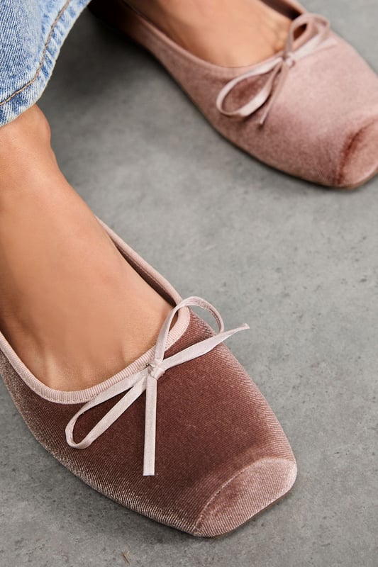 Luxurious velvet ballet pumps with elegant square toe design
        Delicate bow detail on the front for a feminine touch
        Comfortable flat heel measuring between 0-2cm for all-day wear
        Soft cushioned insole providing essential comfort and support
        Versatile slip-on style for effortless dressing
    
    These Faith Minnie Ballet Pumps showcase the timeless appeal of velvet with a contemporary square toe silhouette. The subtle bow detail adds a refined finishing touch to these sophisticated flats. Style them as seen with relaxed denim and a crisp white tee for casual weekend brunches, or pair with tailored trousers and a blouse for office-appropriate chic. The flat heel ensures comfort throughout the day whilst maintaining an elegant profile. Perfect for family gatherings or casual outings where style and comfort are equally important. These versatile pumps transition seamlessly from day to evening, making them an essential addition to your footwear collection. Their classic design ensures they'll remain a wardrobe staple for seasons to come.