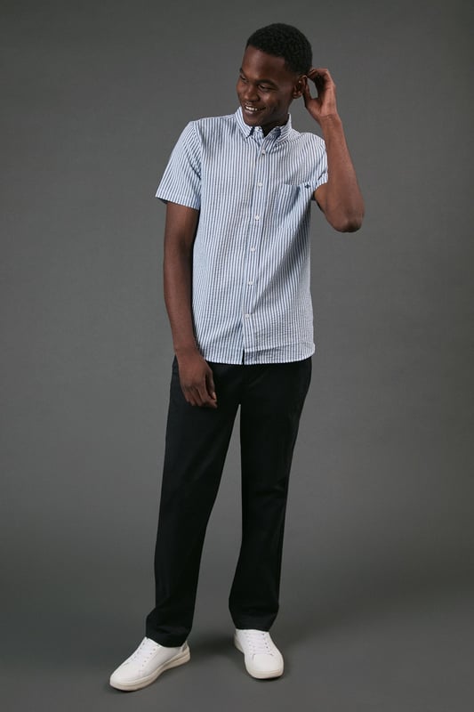Classic button-down collar for a smart-casual finish
        Distinctive seersucker fabric with textured multi-stripe pattern
        Practical chest pocket with Maine brand detailing
        Short sleeves with neat hems for warm-weather comfort
        Box pleat at back for enhanced movement and fit
    
    This Maine seersucker shirt combines timeless style with practical warm-weather design. The textured multi-stripe pattern creates visual interest while the lightweight woven fabric offers breathability perfect for summer days. Style with dark chinos and white trainers for a relaxed weekend look, as shown, or pair with tailored shorts and loafers for garden parties and casual gatherings. The versatile button-down design transitions effortlessly from daytime outings to evening barbecues. For a layered approach, wear unbuttoned over a plain t-shirt with rolled sleeves. The classic fit provides comfortable movement without sacrificing style, making this shirt an essential addition to your casual wardrobe that will serve you well through numerous summer seasons.