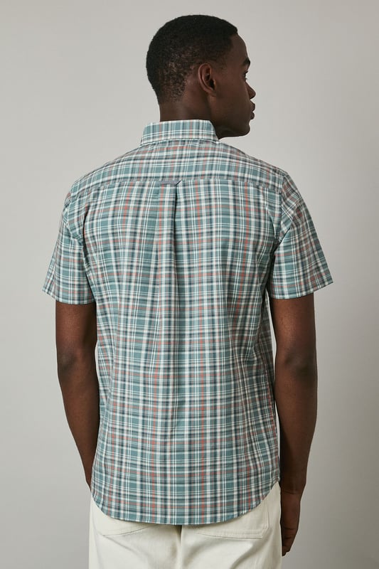 Classic button-down collar for a refined casual look
        Short sleeves with neat hems perfect for warmer weather
        Traditional check pattern adds visual interest and versatility
        Chest pocket with subtle Maine brand detailing
        Regular fit with back pleat for enhanced comfort and movement
    
    This Maine short sleeve shirt showcases a timeless check pattern that brings a touch of sophistication to your summer wardrobe. The button-down collar maintains structure while keeping things casual, making it ideal for various daytime occasions. As seen on our model, pair this versatile shirt with light-coloured shorts and white trainers for an effortlessly stylish weekend look. The shirt works brilliantly for family barbecues, casual garden parties, or relaxed pub lunches with friends. For a smarter appearance, tuck it into chino trousers and add a canvas belt. The breathable fabric ensures comfort during warmer days, while the classic pattern ensures this piece will remain a staple in your collection for seasons to come. Perfect for packing on weekend getaways or summer holidays when you need an easy-to-style option that delivers on both comfort and style.