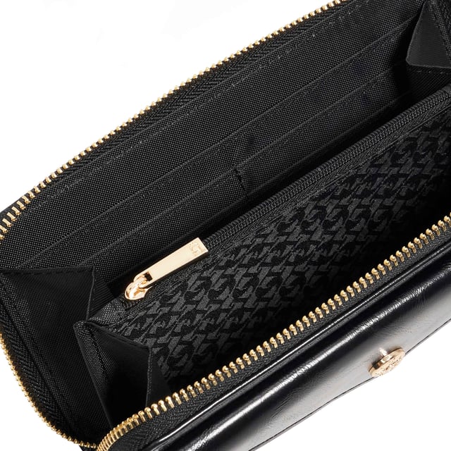Crafted from high-shine black material, the Keyfield purse is as sleek as it is practical. Designed with a zip-around closure, it opens to reveal card slots, two spacious compartments, and a central zip pocket'perfect for keeping essentials organised. A monogrammed lining adds a signature touch, while the front pocket and branded press stud offer extra functionality and polish. Finished with our logo on the front, this everyday essential is elevated with thoughtful detail
